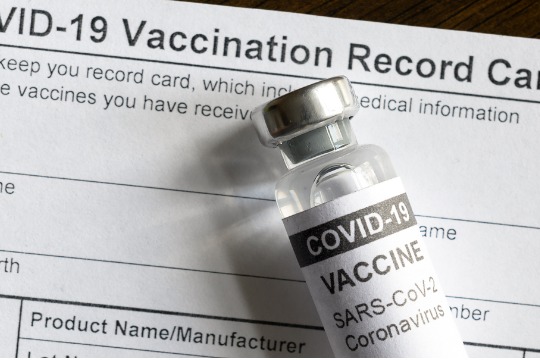 covid-19-vaccine-bottle-on-coronavirus-vaccination-record-card 540x360